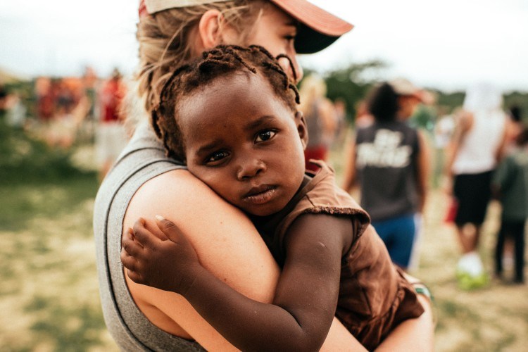 Girl holding a young Haitian child madi-robson