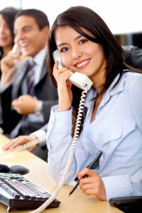 Sales team on phone smiling professional lady on telephone